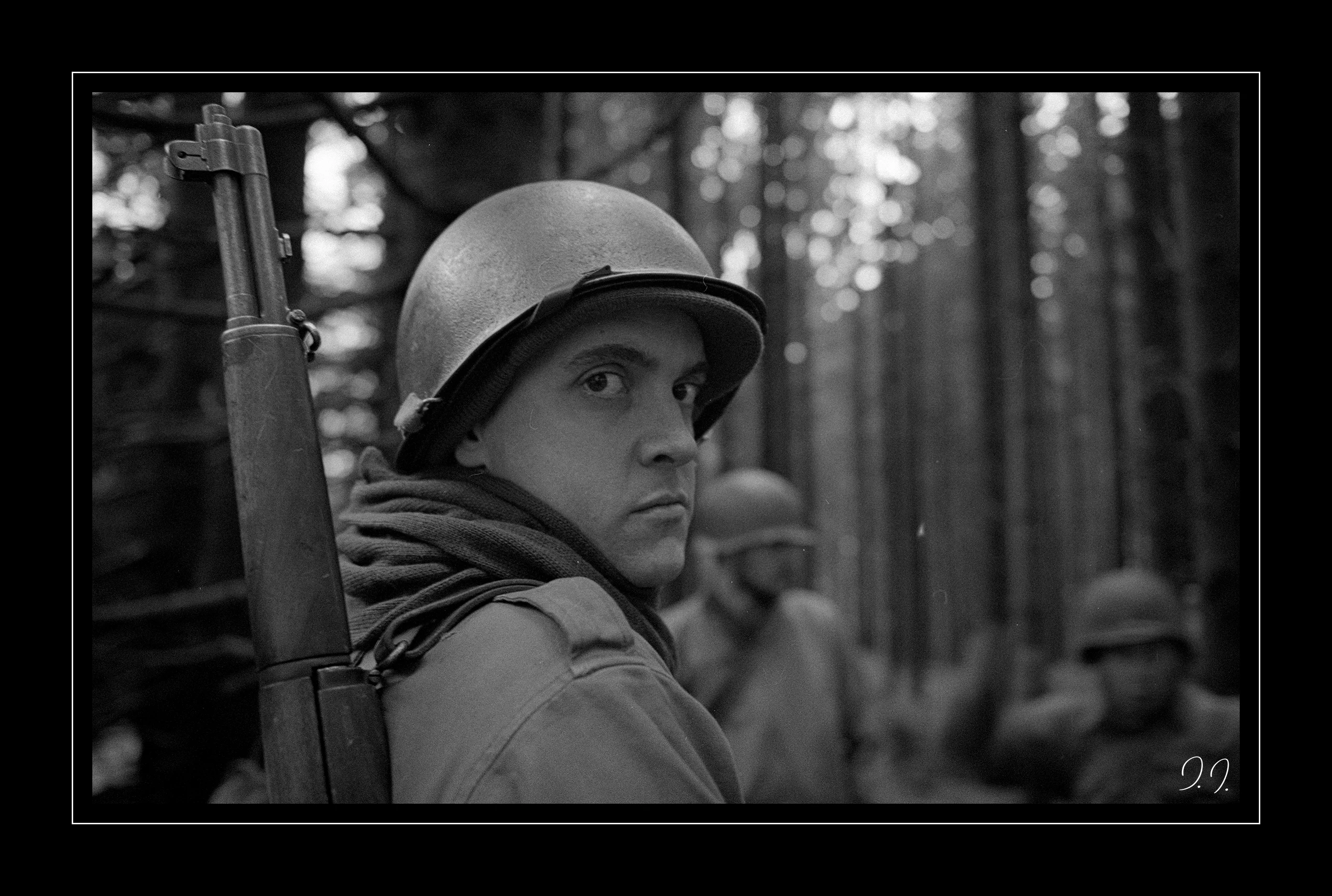 American soldier in profile, rifle and scarf, re-enactment in the forest at Bihain, 2014.